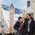 Happy couple in winter clothes on a festively lit city street
