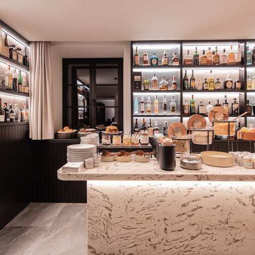 Pamper your palate at this restaurant in Sterzing Modern buffet with breakfast items and illuminated shelves of spirits