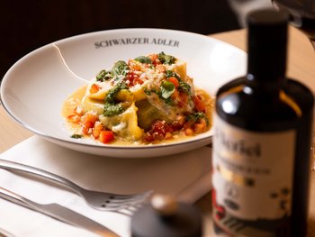 Schwarzer Adler Sterzing: A historic icon. Reinvented. Teller mit Tortellini, Basilikum und Tomaten im Restaurant Schwarzer Adler