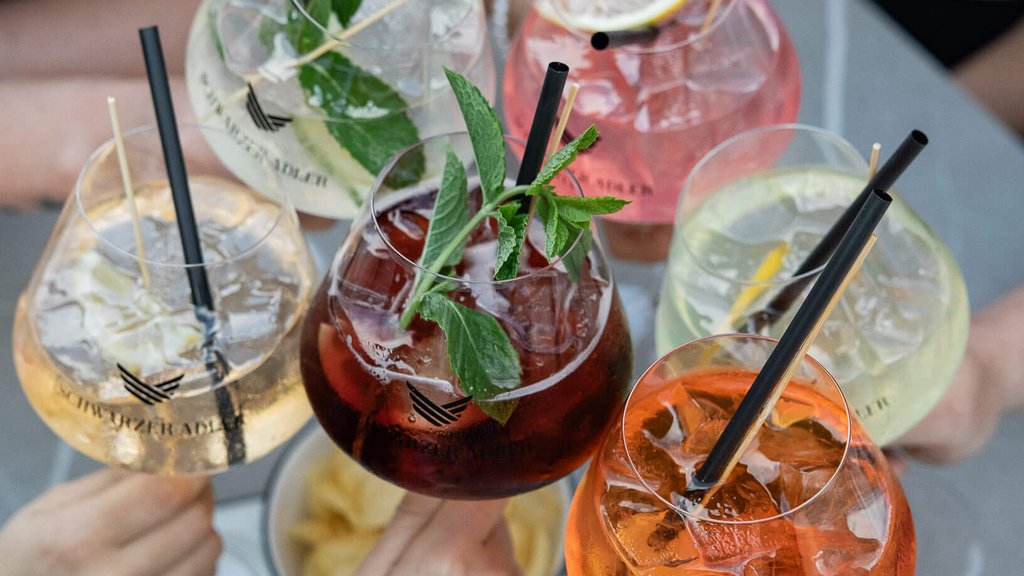 The perfect location for your apartment in Sterzing Five colorful cocktails held by people for a toast