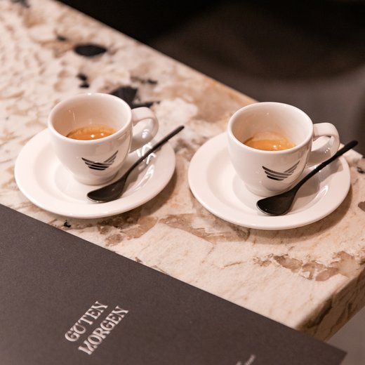 Pamper your palate at this restaurant in Sterzing Two espresso cups and a menu on a marble table