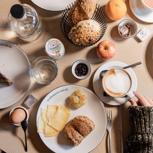 Pamper your palate at this restaurant in Sterzing Breakfast table with bread rolls, cheese, coffee, egg, fruit, and jam